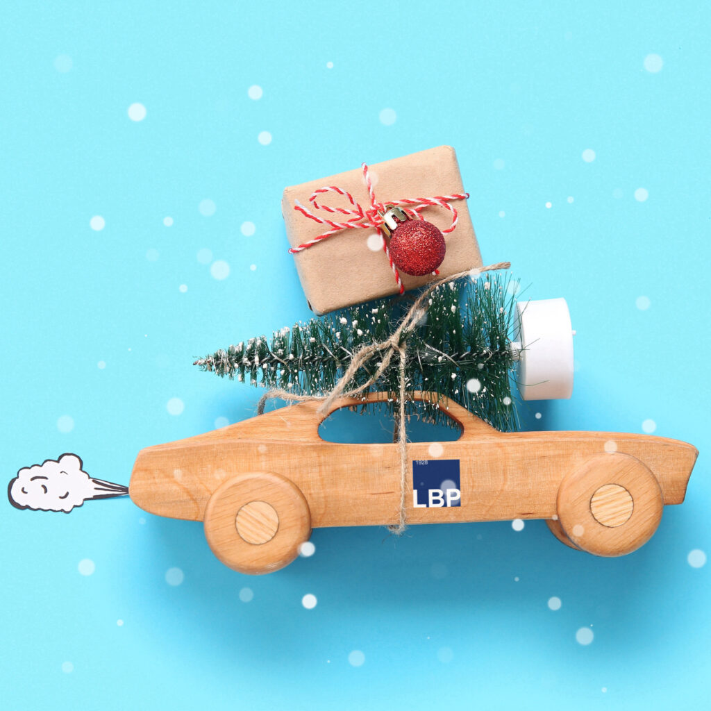 LBP Christmas wishes showing a car with a christmas tree in its roof and a LBP logo on its side
